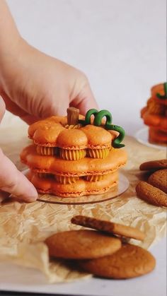 a person is placing cookies on top of each other to make them look like they are stacked