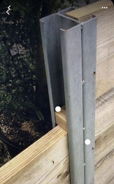 a close up of a piece of wood with metal bars attached to the side of it