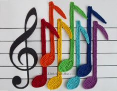 crocheted musical notes are arranged in the shape of a treble