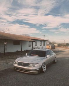 a silver car parked in front of a house