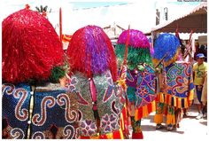 colorfully dressed people walking down the street