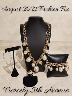 the jewelry set is on display in front of a black mannequin with chains and pearls