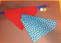 three pieces of fabric are laid out on a cutting board to make an origami dog collar