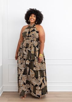 Style #1032BBG Be the Queen of elegance in our Ronke African print maxi dress in our Black Brown Geometric print. It is perfect for family picture day or a special event! Pair it with the matching head wrap. *The head wrap pictured is sold separately* Description: Long maxi dress with halter neck Invisible zipper on center back Hidden Side Pockets Unlined Attached sash 100% African print cotton Imported Length Range 57 1/2" - 59 1/2" Care Instruction: Hand wash separately. Use mild detergent. Do Brown Kitenge Designs, Brown African Print Dresses, Black Ankara Fabric Maxi Dress, Black Geometric Pattern Sleeveless Dress, Modern African Clothing, Brown Sleeveless Tiger Print Dress, African Print Clothing, Halter Maxi, African Fashion Designers