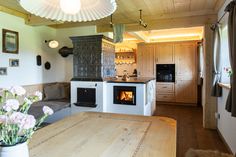 a kitchen with an oven, stove and table in the center is decorated with flowers