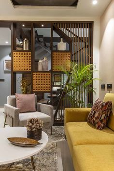 a living room filled with furniture next to a staircase