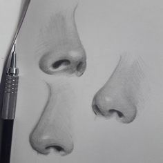 a pencil drawing of two faces with one nose open and the other half closed, next to a pen