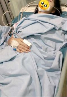 a woman laying in a hospital bed with an oxygen tube