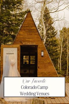 the colorado camp wedding venue is set up on a wooden deck with trees in the background