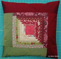 a red and green patchwork quilt on a table