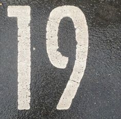 the number ten is painted on the asphalt