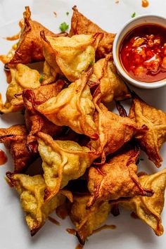 some fried food on a white plate with sauce