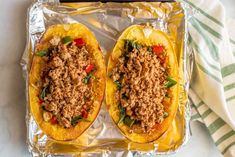 two stuffed squash halves with meat and vegetables