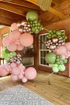 a room filled with lots of balloons and hanging from the ceiling over a wooden floor