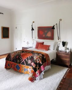 a bed sitting in a bedroom on top of a white rug