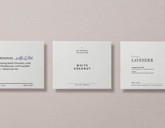 three different types of business cards on top of each other, one with a name and the other without