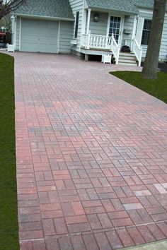 a red brick walkway in front of a house