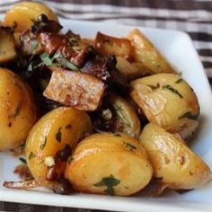 a white plate topped with potatoes and meat