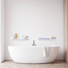 a white bath tub sitting on top of a wooden floor