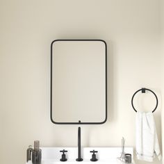 a bathroom sink with a mirror above it and soap dispensers on the counter