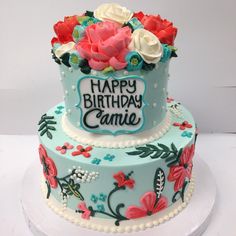 a birthday cake decorated with flowers and the words happy birthday connie on it's side