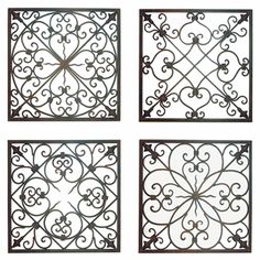 four square iron grilles on the side of a building with an intricate design in black