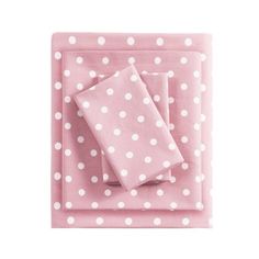 the pink and white polka dot sheet set is folded on it's side, with two