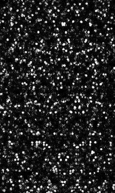 black and white photograph of snow flakes in the night sky with no flash or light