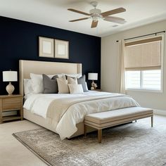 a bedroom with blue walls and white bedding