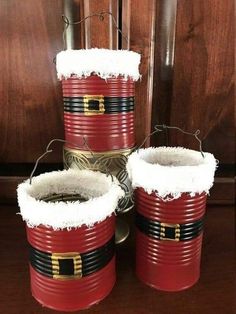 three red buckets with santa claus's belt on them