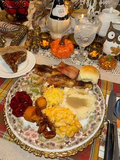 a plate full of food sitting on top of a table next to an owl figurine