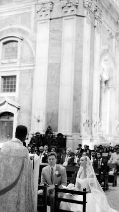 the bride and groom are sitting at the alter