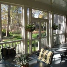 a screened porch with chairs and tables on it