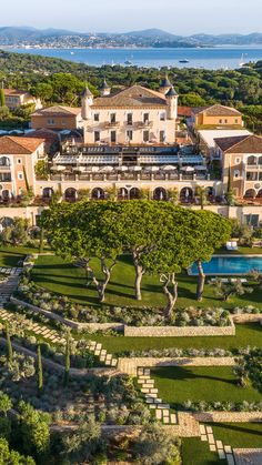 an aerial view of a mansion and gardens