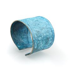 a blue cuff bracelet on a white background