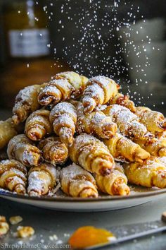 powdered sugar sprinkled pastries on a plate