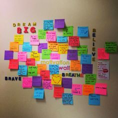 a bulletin board covered in post it notes and magnets with words written on them