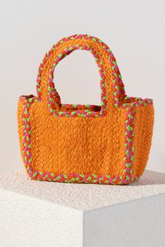 Add a pop of color to your summer outfits with Shiraleah's Liv Small Tote. This compact bag can fit your favorite items and features sturdy double handles. Made from woven jute, the orange color is accented with pink and green stitching to dazzle alongside any outfit. Pair with other items from Shiraleah to complete your look! Eco-friendly Orange Rectangular Straw Bag, Casual Orange Shopping Bag, Trendy Orange Rectangular Beach Bag, Casual Orange Bag With Double Handle, Casual Orange Shoulder Bag With Double Handle, Orange Summer Crochet Bag For Beach, Orange Crochet Travel Bag For Summer, Orange Crochet Summer Beach Bag, Orange Rectangular Beach Bag For Summer