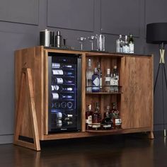 a wooden cabinet with bottles and glasses in it