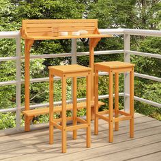 two wooden stools sitting on top of a wooden deck next to a table and chair