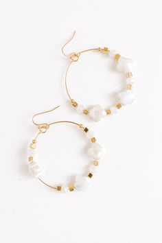 - Fall head over heels for these chic earrings! - Gold colored metal material - Dangling hoops - Shimmering clover shaped beading with gold accent beads - Hook backs - Size: 2 inches Adjustable Nickel-free White Hoop Earrings, Adjustable White Nickel Free Hoop Earrings, White Metal Hoop Jewelry, White Gold Beaded Drop Earrings, Nickel Free Small Hoop White Jewelry, White Small Hoop Beaded Earrings Nickel Free, Adjustable White Hoop Earrings With Ear Wire, White Nickel-free Small Hoop Beaded Earrings, White Metal Beaded Earrings With Ear Wire