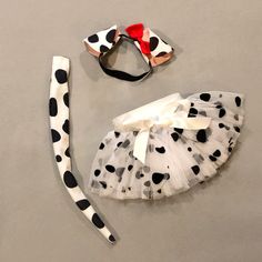 a dalmatian costume and headband for a baby girl