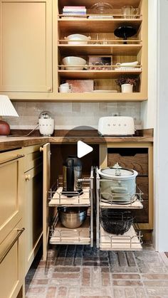 two pots and pans are sitting in the middle of a kitchen cabinet with open shelves