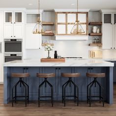 a kitchen with white cabinets and blue island