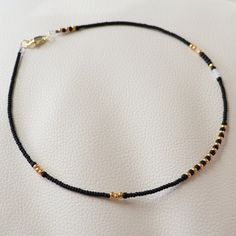 Bead choker necklace made with beautifully colored Miyuki Beads. 14K gold plated 316 stainless steel lobster claw clasp.  This is one of the matching necklaces for couples or best friends. Here is the link for the pair of necklaces: https://www.etsy.com/listing/1693023389/best-friend-necklace-friendship-jewelry?click_key=61d0528460b37b07a3d2a75b1bf2b80d669e0081%3A1693023389&click_sum=c00ce142&ref=shop_home_active_8&pro=1&frs=1 See more seed bead necklaces at my store:  https://www.etsy.com/shop/ Gold Beaded Necklaces With Black Beads For Festivals, Gold Beaded Necklace With Black Beads For Festivals, Festival Gold Beaded Bracelets With Black Beads, Gold Beaded Bracelets With Black Beads For Festivals, Minimalist Adjustable Beaded Necklace With Gold Beads, Gold Choker With Tiny Beads, Gold Choker With Tiny Round Beads, Gold Choker With Colorful Round Beads, Gold Choker With Round Beads