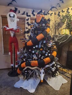 a decorated christmas tree in the shape of a beetle and jack - o - lantern