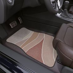 the interior of a car with an area rug on the floor that looks like waves