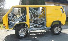 a small yellow truck parked in front of a house