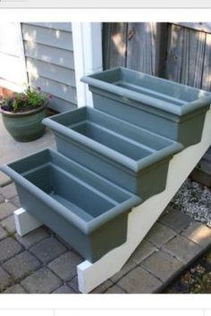 an outdoor planter made out of plastic containers