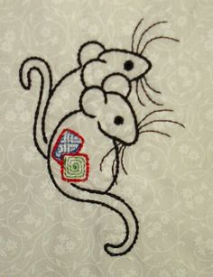 the embroidered mouse is holding a piece of paper